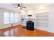 Cozy living room with hardwood floors, fireplace, and built-in shelving at 155 Glenwood Ln, Fayetteville, GA 30215