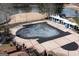 Aerial view of community pool covered for the off-season with lounge chairs nearby at 155 Glenwood Ln, Fayetteville, GA 30215