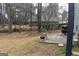 Cozy patio with a grill and outdoor seating offers a private backyard setting, enclosed by a chain-link fence and lush trees at 3281 Nina Way, Douglasville, GA 30135