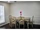 Inviting dining room with wooden table and chairs complemented by natural light from a nearby window at 3281 Nina Way, Douglasville, GA 30135
