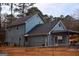 Two-story home featuring a well-maintained lawn, a covered parking area, and a blue exterior with a dark roof at 3281 Nina Way, Douglasville, GA 30135
