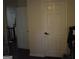 Hallway with white walls, dark flooring and a closed door at 3281 Nina Way, Douglasville, GA 30135