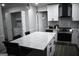 Bright kitchen featuring a spacious island with white countertop, modern appliances and a washer/dryer at 3281 Nina Way, Douglasville, GA 30135