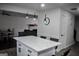 Open-concept kitchen island with white marble countertops and pendant lighting, with view into the living room at 3281 Nina Way, Douglasville, GA 30135