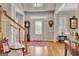 Inviting foyer with hardwood floors, a stained glass front door, and a grandfather clock at 142 Kenton Pl, Peachtree City, GA 30269