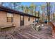 Backyard patio with grill, wooden benches and table, and a partial view of the yard at 11800 Pine Needle Ln, Hampton, GA 30228