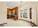 A combination kitchen and dining area featuring wood cabinets, appliances, and ample natural light at 11800 Pine Needle Ln, Hampton, GA 30228