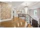 Spacious foyer with hardwood floors, a graceful staircase, and an elegant chandelier at 2242 Sxxxx Xxxx Rd, Buford, GA 30518