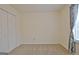 Bedroom featuring neutral walls, carpet, closet, and window with grey curtains at 120 Fen Way, Peachtree City, GA 30269