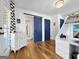 A stylish bedroom featuring hardwood floors and barn door access to an ensuite bathroom with tiled floors at 10528 Serenbe Ln, Chattahoochee Hills, GA 30268