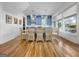 Bright kitchen and dining area features custom blue cabinetry, hardwood flooring and pendant lighting at 10528 Serenbe Ln, Chattahoochee Hills, GA 30268