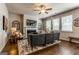 Comfortable living room with a ceiling fan, TV, fireplace, and windows with natural light at 113 Maplewood Ln # 176, Conyers, GA 30094