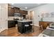 Kitchen with island, stainless steel appliances, dark cabinets, and granite countertops at 113 Maplewood Ln # 176, Conyers, GA 30094