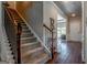 Carpeted staircase with wooden handrail leads to upper level, complemented by hardwood floors at 113 Maplewood Ln # 176, Conyers, GA 30094