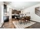 Open concept dining area with dark wood floors, modern light fixture and staircase views at 113 Maplewood Ln # 176, Conyers, GA 30094