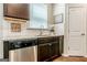 Kitchen area with a stainless steel dishwasher, sink, and modern granite countertops at 113 Maplewood Ln # 176, Conyers, GA 30094