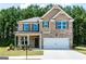 Attractive two-story home featuring brick facade, gray accents, attached garage, and well-maintained lawn at 113 Maplewood Ln # 176, Conyers, GA 30094
