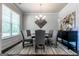 Inviting dining area features a glass-top table with seating for six, enhanced by natural light at 113 Maplewood Ln # 176, Conyers, GA 30094