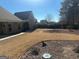 Large backyard featuring a well-maintained lawn, mature trees, and decorative rock areas at 828 Cedar Stream Ct, Loganville, GA 30052