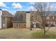Brick home with a spacious backyard featuring a patio area and lush lawn at 243 Long Dr, Mcdonough, GA 30253