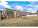Wide backyard featuring a well-maintained lawn, mature trees, and a serene view of the property at 243 Long Dr, Mcdonough, GA 30253
