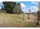 Spacious backyard with mature trees, a patio with covering, and a well-maintained lawn at 243 Long Dr, Mcdonough, GA 30253
