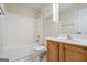 Bathroom features a shower and tub combination with tile flooring and a wooden vanity at 243 Long Dr, Mcdonough, GA 30253
