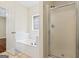 Bathroom with a glass door shower and soaking tub at 243 Long Dr, Mcdonough, GA 30253