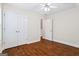 A light and bright bedroom with hardwood flooring, a ceiling fan, and ample closet space at 243 Long Dr, Mcdonough, GA 30253