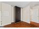 A bedroom with hardwood floors and a closet with mirrored sliding doors at 243 Long Dr, Mcdonough, GA 30253