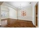 Elegant dining room featuring hardwood floors, a chandelier, and a decorative window at 243 Long Dr, Mcdonough, GA 30253