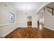Dining room with hardwood floors and decorative window, leading to the kitchen and living room at 243 Long Dr, Mcdonough, GA 30253