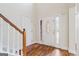 Foyer with wood floors featuring a decorative front door and staircase with white railing at 243 Long Dr, Mcdonough, GA 30253