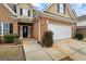 Close-up view of the home's front entrance, showcasing brickwork, landscaping, and two car garage at 243 Long Dr, Mcdonough, GA 30253