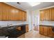 Kitchen featuring granite counters, wooden cabinetry, and tile flooring with access to living spaces at 243 Long Dr, Mcdonough, GA 30253