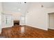 Spacious living room featuring hardwood floors and a brick fireplace at 243 Long Dr, Mcdonough, GA 30253