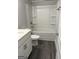 Bathroom with white vanity, toilet, and shower over tub with gray walls and dark gray flooring at 3382 Milan Ct # 3 Plapprox Sqft 3, Douglasville, GA 30135
