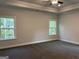 Large bedroom with tray ceiling, carpet, and two large windows providing natural light at 3382 Milan Ct # 3 Plapprox Sqft 3, Douglasville, GA 30135