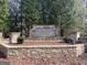 Stone entrance sign for Tuscany Hills community, surrounded by mature trees and landscaping at 3382 Milan Ct # 3 Plapprox Sqft 3, Douglasville, GA 30135