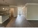 Well-lit hallway with hardwood floors leads to the kitchen, pantry, and front entrance at 3382 Milan Ct # 3 Plapprox Sqft 3, Douglasville, GA 30135