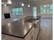 Kitchen island with gray countertop, stainless farmhouse sink, and view into open concept living space at 3382 Milan Ct # 3 Plapprox Sqft 3, Douglasville, GA 30135