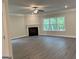 Spacious living room featuring hardwood floors, a fireplace, and large windows at 3382 Milan Ct # 3 Plapprox Sqft 3, Douglasville, GA 30135