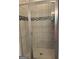 Walk-in shower featuring decorative accent tile, glass door, and tiled floor at 3382 Milan Ct # 3 Plapprox Sqft 3, Douglasville, GA 30135