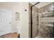 Modern bathroom features a tiled shower with glass door and pebble floor at 20 Manor Oak Ln, Covington, GA 30014