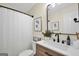 Bathroom featuring updated vanity with matte black faucet and floral artwork at 20 Manor Oak Ln, Covington, GA 30014