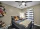 Cheerful bedroom with soft lighting, a ceiling fan, and a gray-toned bed at 20 Manor Oak Ln, Covington, GA 30014