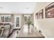 A dining area with a wooden table, neutral walls, and natural light filtering through the windows at 20 Manor Oak Ln, Covington, GA 30014