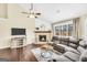 Inviting living room with a cozy fireplace, large windows, and comfortable seating for relaxation at 20 Manor Oak Ln, Covington, GA 30014