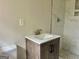 Updated bathroom with wood vanity and white marble tile shower at 2037 Mesa Se Dr, Atlanta, GA 30316