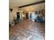 Spacious living room featuring tile floors, dark wooden beams, and sliding glass doors to the back at 8463 Alden Dr, Riverdale, GA 30274